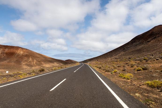 an empty road in the middle of a desert